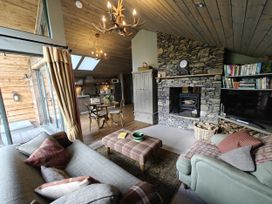 A living room with a fireplace and sofa at The Hare's Shack, Garnett Bridge, Longsleddale. Near Kendal