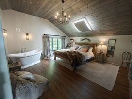 A bedroom with a bed and bathtub at The Hare's Shack in Garnett Bridge, Longsleddale Near Kendal