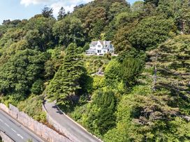 A house on a hill surrounded by trees at Afallon in Menai Bridge