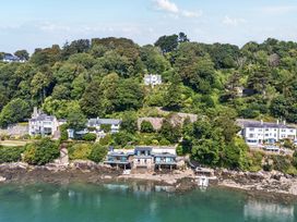 A view of houses on a hillside by the water at Afallon in Menai Bridge