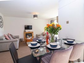 A living room with sofa and dining area at 13 Manorcombe Bungalows Honicombe Holiday Village near Gunnislake