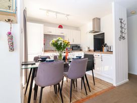A kitchen with a dining table and chairs at 13 Manorcombe Bungalows Honicombe Holiday Village near Gunnislake