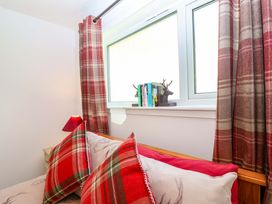 A bedroom with a bed and window at 13 Manorcombe Bungalows Honicombe Holiday Village near Gunnislake
