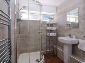 A bathroom with a shower, sink, and towel rack at 13 Manorcombe Bungalows Honicombe Holiday Village near Gunnislake