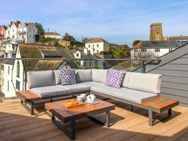 A sofa and coffee table with a view at The Penthouse in Salcombe