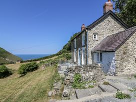 A house with a garden and patio overlooking the sea at Dolwylan Cottage Cwmtydu near New Quay
