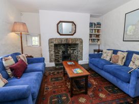 A living room with sofas and a coffee table at Dolwylan Cottage in Cwmtydu near New Quay