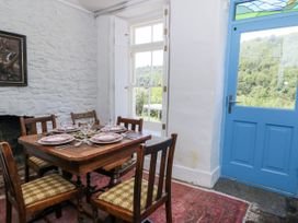 A dining room with a table set for guests at Dolwylan Cottage Cwmtydu near New Quay