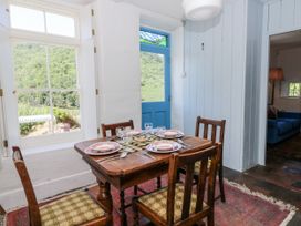 A dining room with a table set for a meal at Dolwylan Cottage Cwmtydu near New Quay