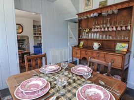 A dining room with a table set for dinner at Dolwylan Cottage in Cwmtydu near New Quay
