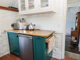 A kitchen with a kettle and microwave at Dolwylan Cottage Cwmtydu near New Quay