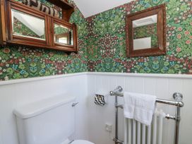 A bathroom with a toilet and a towel rack at Dolwylan Cottage in Cwmtydu near New Quay