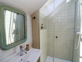 A bathroom with a sink and shower at Dolwylan Barn Cwmtydu near New Quay
