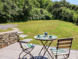A table with chairs and teapot at Dolwylan Barn in Cwmtydu near New Quay