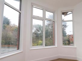 A living room with large windows at Beachwalk Villa 1