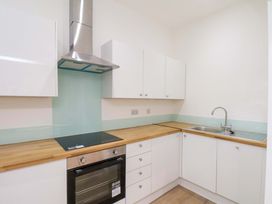 A kitchen with countertop, sink, oven, and cabinets at Beachwalk Villa 1