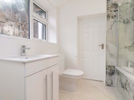 A bathroom with a sink and toilet at Beachwalk Villa 1