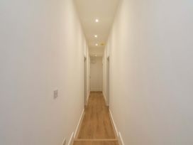 A hallway with light fixtures and doors at Beachwalk Villa 1
