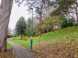A pathway with a lamp post and trees at Beachwalk Villa 1