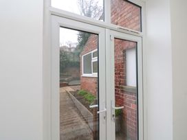 A view of a door and window leading to a garden area at Beachwalk Villa 1