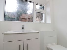 A bathroom with a sink and toilet at Beachwalk Villa 1