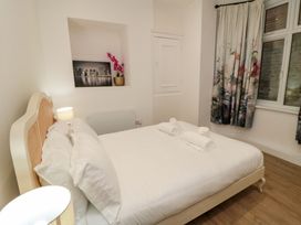A bedroom with a bed and towels arranged on it at Beachwalk Villa 1 in Whitby