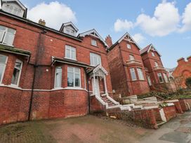 A brick building with windows and steps at Beachwalk Villa 1 in Whitby
