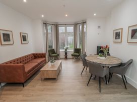 A living room with a sofa and dining area at Beachwalk Villa 1 in Whitby