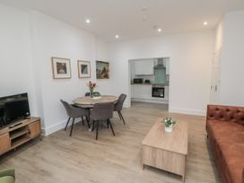 A living room with a dining area and kitchen at Beachwalk Villa 1 in Whitby
