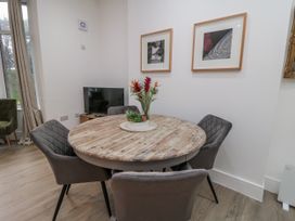 A dining room with a round table and four chairs at Beachwalk Villa 1 in Whitby