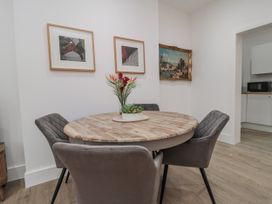 A dining room with a round table and chairs at Beachwalk Villa 1 in Whitby