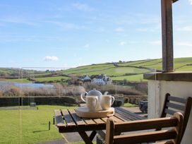 A tea set on a table with a view at 10 Oceans Edge in Thurlestone