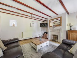 A living room with a sofa and coffee table at Tyn Y Ffynnon in Betws-Y-Coed