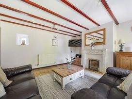 A living room with a sofa and coffee table at Tyn Y Ffynnon in Betws-Y-Coed
