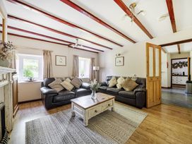 A living room with a sofa and coffee table at Tyn Y Ffynnon in Betws-Y-Coed