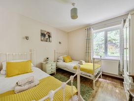 A bedroom with two beds and a nightstand at Tyn Y Ffynnon in Betws-Y-Coed