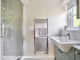 A bathroom with a shower and wash basin at Tyn Y Ffynnon in Betws-Y-Coed
