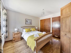 A bedroom with a bed and a nightstand at Tyn Y Ffynnon in Betws-Y-Coed