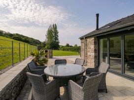 An outdoor patio with a table and chairs at Limestone in Great Urswick