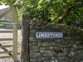 A sign labeled Limestones on a stone wall at Limestone in Great Urswick