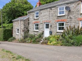 A stone house with a garden at 2 Cliff Cottages in West Portholland near Gorran Haven