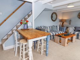 A living room with a table and chairs at 2 Cliff Cottages in West Portholland near Gorran Haven