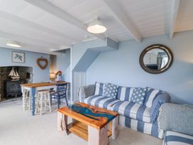 A living room with a sofa and coffee table at 2 Cliff Cottages in West Portholland near Gorran Haven