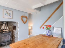 A dining room with a table and chair at 2 Cliff Cottages West Portholland near Gorran Haven