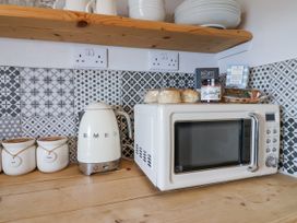 A kitchen with a microwave and kettle at 2 Cliff Cottages West Portholland near Gorran Haven