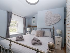 A bedroom with a bed and window at 2 Cliff Cottages in West Portholland near Gorran Haven