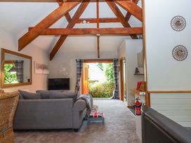 A living room with a sofa and television at Little Torr in Drewsteignton