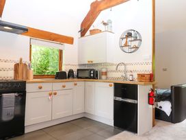 A kitchen with cabinets, sink, and appliances at Little Torr in Drewsteignton