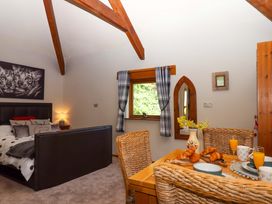 A bedroom with a bed and dining table at Little Torr in Drewsteignton