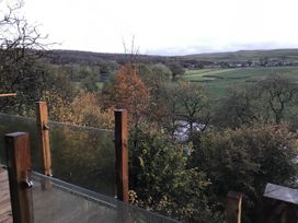 A view of a landscape with trees and a stream at The Sett on the Wharfe, Skipton